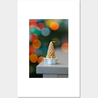 Christmas tree shaped candle on wooden cupboard against christmas lights Posters and Art